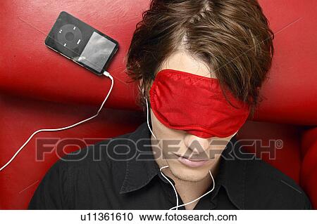 Young Man Wearing Sleep Mask and Listening to MP3 Player View Large Photo Image Stock Image - Young Man Wearing Sleep Mask and Listening to MP3 Player. Fotosearch