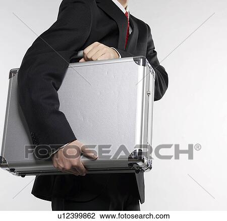 Stock Image - Businessman Carrying Briefcase. Fotosearch