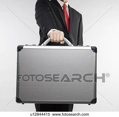 Stock Photography - Businessman Holding Briefcase. Fotosearch