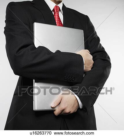 Businessman Holding Laptop View Large Photo Image Stock Image - Businessman Holding Laptop. Fotosearch