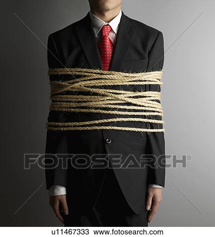 Stock Image - Businessman Tied with Rope. Fotosearch