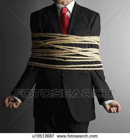 Stock Photo - Businessman Tied with Rope. Fotosearch