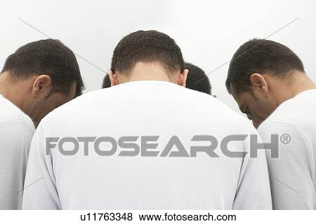 Stock Photo - Man facing mirror, looking down. Fotosearch