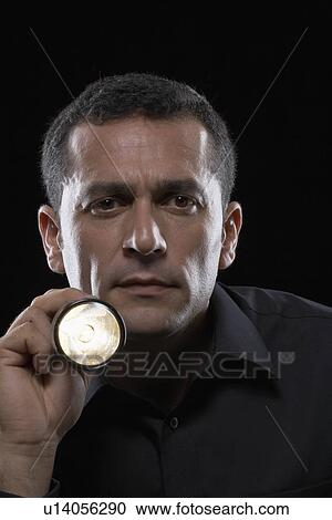 Man holding torch Stock Image | u14056290 | Fotosearch