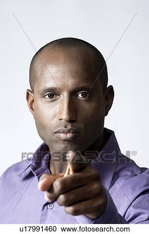 Mid adult man pointing at camera View Large Photo Image Stock Image - Mid adult man pointing at camera. Fotosearch
