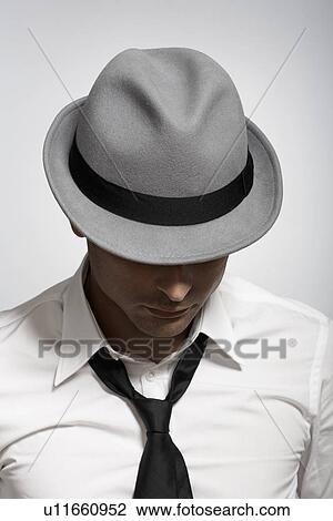 Mid adult man wearing fedora View Large Photo Image Stock Image - Mid adult man wearing fedora. Fotosearch