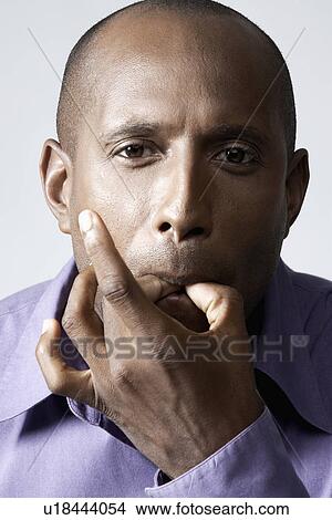 Mid adult man whistling with fingers View Large Photo Image Picture - Mid adult man whistling with fingers. Fotosearch