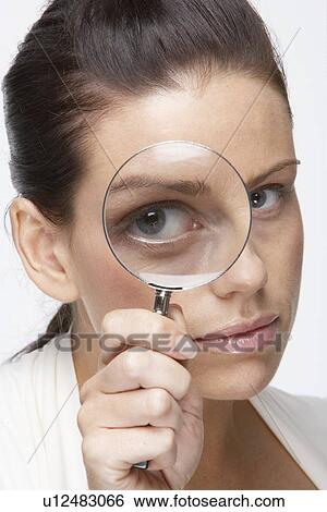 Mid adult woman looking through magnifying glass View Large Photo Image Stock Photograph - Mid adult woman looking through magnifying glass. Fotosearch