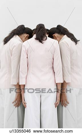 Stock Photograph - Woman facing mirror, looking down. Fotosearch