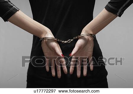 Woman in handcuffs (close-up, focus on hands) View Large Photo Image Stock Photo - Woman in handcuffs (close-up, focus on hands). Fotosearch