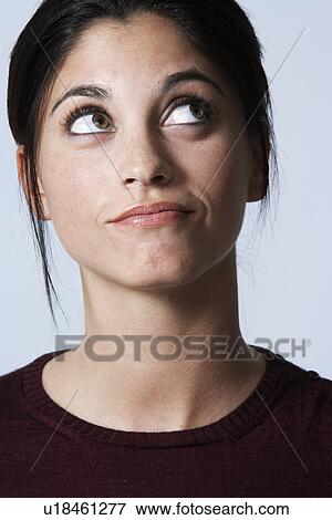 Young woman looking up View Large Photo Image Stock Photo - Young woman looking up. Fotosearch