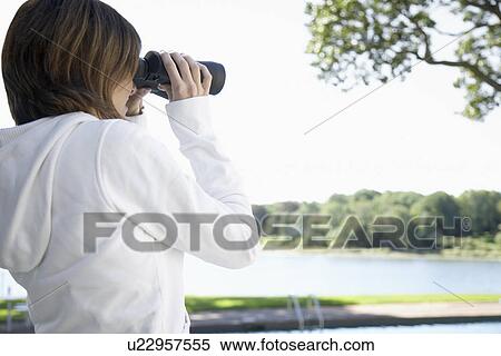 Woman using binoculars View Large Photo Image Stock Photography - Woman using binoculars. Fotosearch