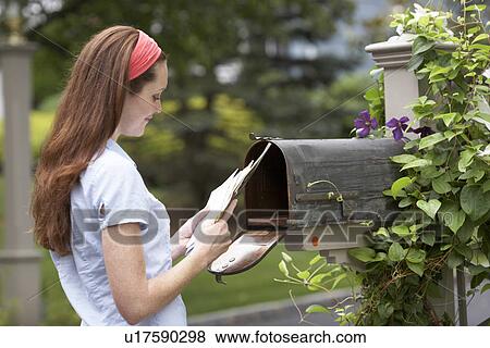Stock Photo - Young woman collecting post. Fotosearch