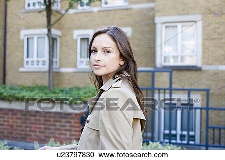 Young woman near apartment building View Large Photo Image Stock Image - Young woman near apartment building. Fotosearch