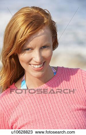 Stock Image - Young woman smiling (portrait). Fotosearch