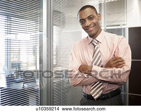 Businessman by window (portrait) View Large Photo Image Picture - Businessman by window (portrait). Fotosearch