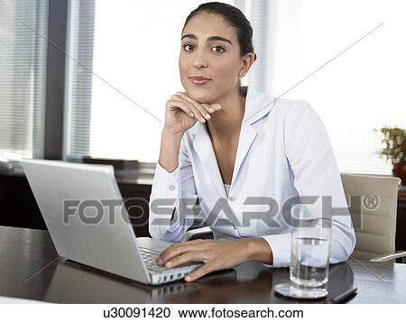 Businesswoman using laptop computer (portrait) View Large Photo Image Stock Image - Businesswoman using laptop computer (portrait). Fotosearch