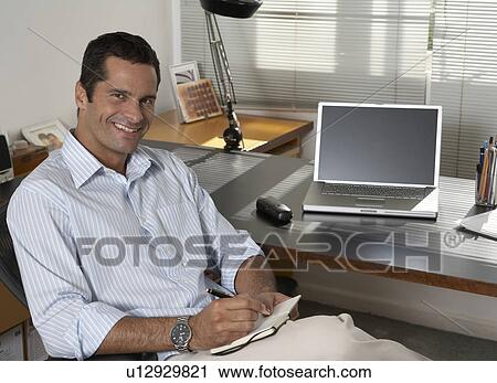 Mid Adult Businessman at Desk View Large Photo Image Stock Image - Mid Adult Businessman at Desk. Fotosearch