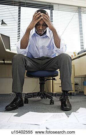 Mid Adult Man Doing Paperwork View Large Photo Image Stock Photography - Mid Adult Man Doing Paperwork. Fotosearch