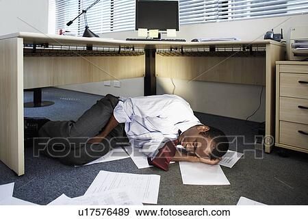 Stock Photo - Mid Adult Man Sleeping Near Documents on Floor. Fotosearch