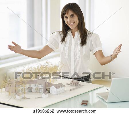 Stock Image - Mid-Adult Woman With Architectural Model. Fotosearch
