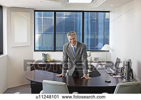 Stock Image - Portrait of Ceo in His Office. Fotosearch