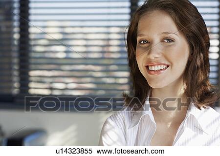 Stock Photography - Portrait of young female office worker. Fotosearch
