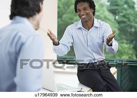 Two businessmen talking View Large Photo Image Stock Photo - Two businessmen talking. Fotosearch