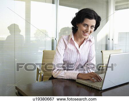Young businesswoman using laptop computer (portrait) View Large Photo Image Stock Photo - Young businesswoman using laptop computer (portrait). Fotosearch