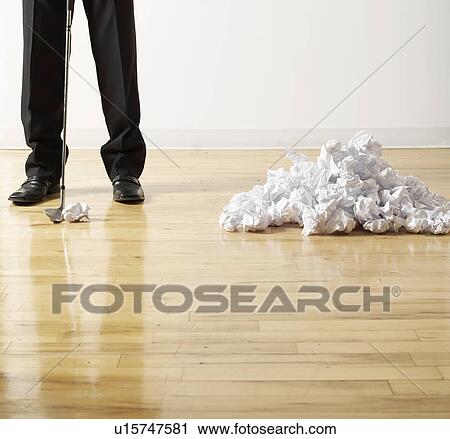 Stock Image - Businessman Playing Golf with Crumpled Paper. Fotosearch