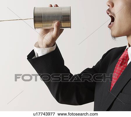 Businessman Shouting into Tin Can Phone View Large Photo Image Stock Photo - Businessman Shouting into Tin Can Phone. Fotosearch