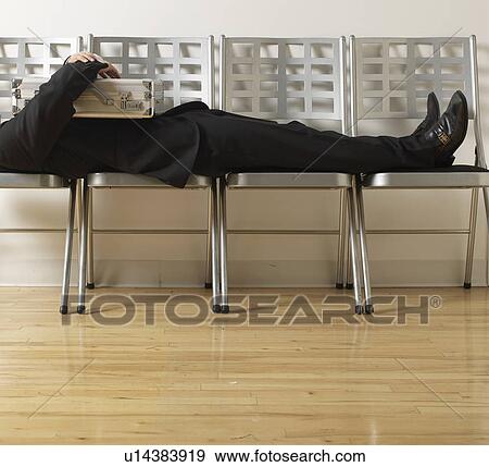 Stock Photo - Businessman Sleeping on Folding Chairs. Fotosearch