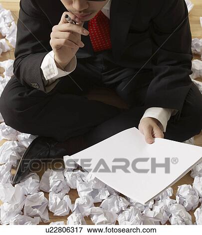 Businessman Thinking beside Crumpled Paper View Large Photo Image Stock Photo - Businessman Thinking beside Crumpled Paper. Fotosearch