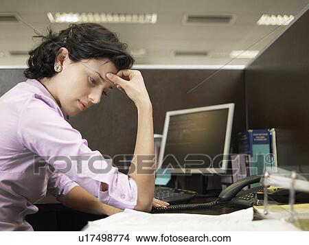 Female office worker reading documents at desk View Large Photo Image Picture - Female office worker reading documents at desk. Fotosearch