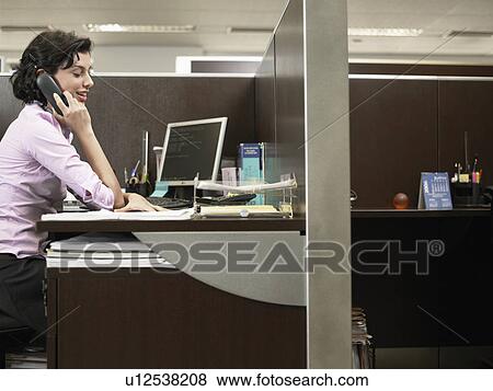 Stock Photo - Office worker talking on phone. Fotosearch