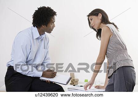 Two architects working by desk View Large Photo Image Stock Image - Two architects working by desk. Fotosearch