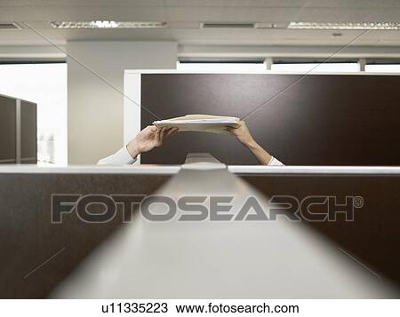 Two office workers passing files over partition wall View Large Photo Image Stock Image - Two office workers passing files over partition wall. Fotosearch