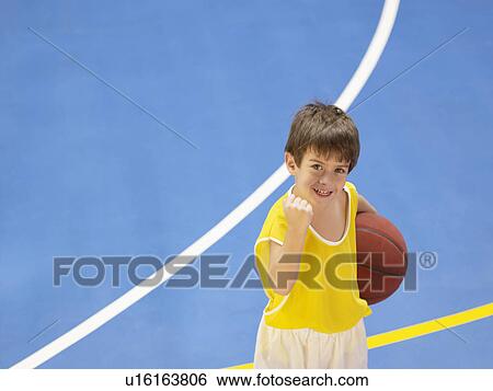 Boy holding basketball and celebrating (portrait, high angle view) View Large Photo Image Stock Photograph - Boy holding basketball and celebrating (portrait, high angle view). Fotosearch
