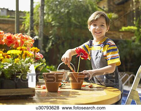 Stock Photo - Boy planting flowers. Fotosearch