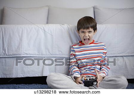 Boy playing video games View Large Photo Image Stock Photo - Boy playing video games. Fotosearch
