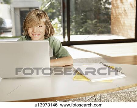 Boy using laptop computer (portrait) View Large Photo Image Stock Photograph - Boy using laptop computer (portrait). Fotosearch