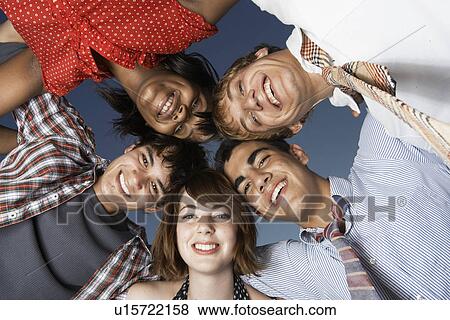 Stock Photo - Five teenagers in a huddle (directly below). Fotosearch