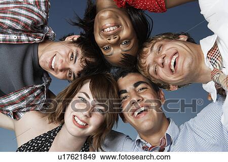 Stock Photo - Five teenagers in a huddle (directly below). Fotosearch