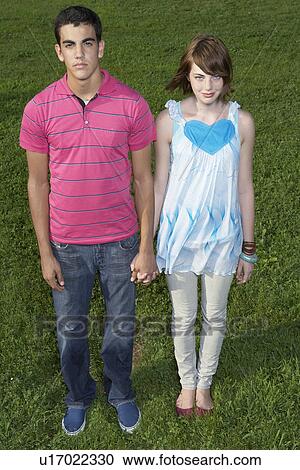 Stock Image - Portrait of teenage couple (high angle view). Fotosearch