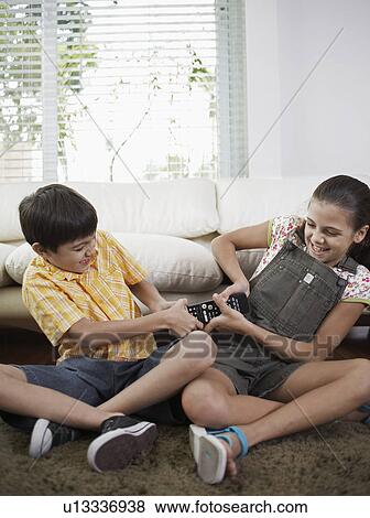 Stock Photo - Sister and Brother Fighting Over Remote Control. Fotosearch