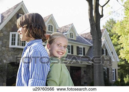 Sister and brother standing back to back View Large Photo Image Stock Photograph - Sister and brother standing back to back. Fotosearch