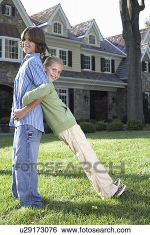 Sister and brother standing back to back with arms linked, Chatham, New Jersey, USA View Large Photo Image Stock Photograph - Sister and brother standing back to back with arms linked, Chatham, New Jersey, USA. Fotosearch