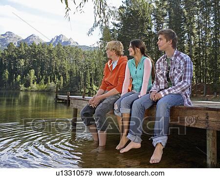 Stock Photo - Three Teenagers at Lake. Fotosearch