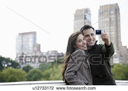 Couple photographing themselves View Large Photo Image Stock Image - Couple photographing themselves. Fotosearch
