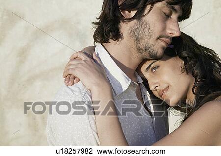 Stock Image - Young couple hugging. Fotosearch